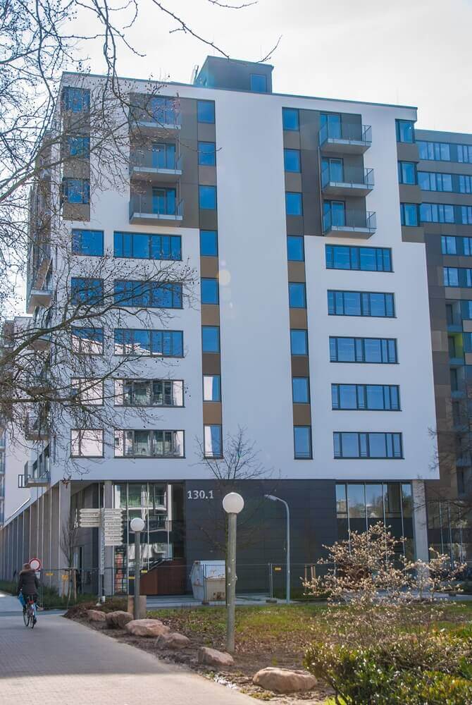 High-rise building of a student residence with many windows and balconies, marked with house number 130.1